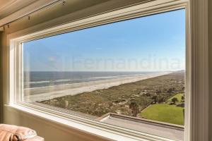 a window with a view of the beach at Amelia South - B7 in Fernandina Beach