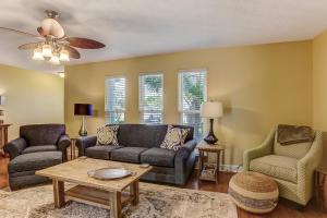a living room with a couch and two chairs and a table at Fernandina Shores Condo in Fernandina Beach