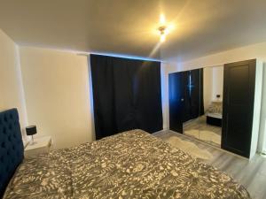 a bedroom with a bed and a ceiling fan at Comfy one bedroom apartment in Barking