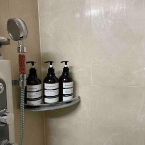 three bottles on a shelf in the corner of a bathroom at 5sec from station, cosy house in Seoul +30 photos