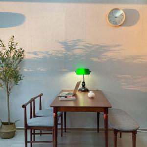 a table with a lamp and a laptop on it at 5sec from station, cosy house in Seoul
