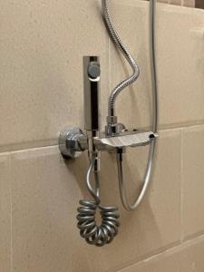 a shower head is attached to a wall at شقة Noya غرفة وصاله بدخـول ذاتي in Taif +21 photos
