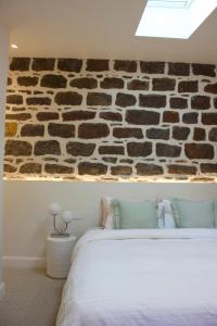 Ένα ή περισσότερα κρεβάτια σε δωμάτιο στο The Cottage