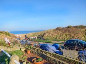 a car parked in a parking lot next to a beach at Smugglers' Cottage in Marske-by-the-Sea +4 photos