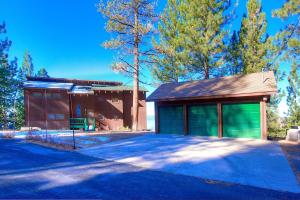a house with green garage doors on a street at Lake View Glen home in Lincoln Park