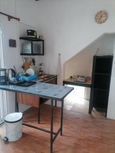a kitchen with a table in the middle of a room at studio maryphil in Saint-Martin