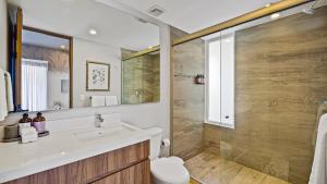 a bathroom with a sink and a shower at Stunning Beachfront Condo - Sea Views & Pools in Puerto Vallarta