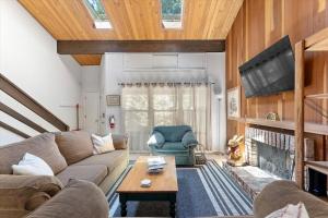 a living room with a couch and a fireplace at Raccoon Roost condo in Incline Village