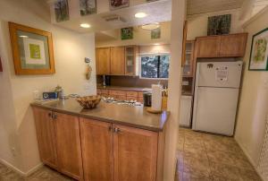 Una cocina con gabinetes de madera y un refrigerador blanco. en Sugar PIne home, en Incline Village