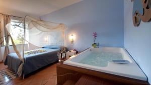 a bedroom with a bath tub and a bed at Albergo 'La Vigna' in Procida +37 photos