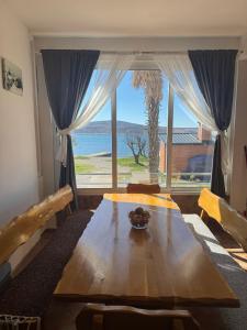 a dining room with a table and a large window at Apartments by the sea Seline, Paklenica - 6528 in Seline