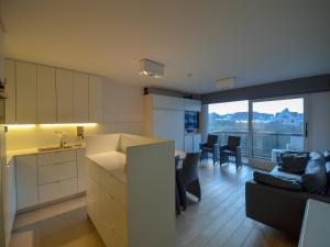 a kitchen and living room with a couch and a table at Studio in Belgium near Beach & Dunes in Oostduinkerke