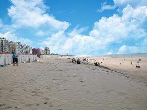 a group of people sitting on the beach at Studio in Belgium near Beach & Dunes in Oostduinkerke