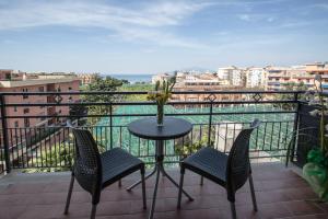 a table and chairs on a balcony with a view at Sea Room Sorrento in Sorrento +19 photos