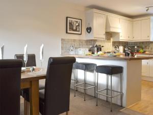 a kitchen with a island with bar stools at Rolton House in Ambleside