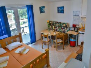 a living room with a table and a kitchen at Apartment in Croatia near Adriatic Coast in Senj