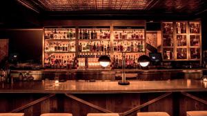 a bar with a lot of bottles of alcohol at Kimpton Palladian Hotel by IHG in Seattle +92 photos