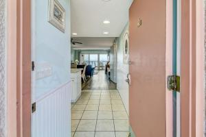a hallway with a door leading into a room at Striking Oceanview Condo in Fernandina Beach