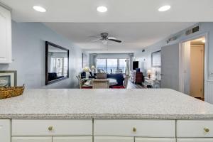 a kitchen and living room with a large counter top at Striking Oceanview Condo in Fernandina Beach +40 photos