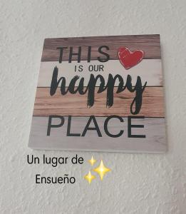a sign that says this is our happy place on a wall at Habitación Matrimonio Espaciosa en Vivienda Compartida in Valencia