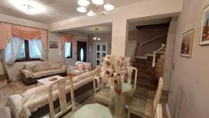 a living room with a couch and a table at Lux Center Apartment in Litochoro