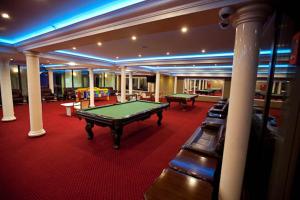 a pool table in a large room with columns at Hotel Dobosz in Police