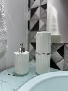 two white toothbrushes sitting on top of a bathroom sink at Pousada Suíte Suzena in Penha