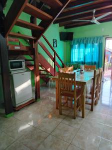 a kitchen and dining room with a table and chairs at Cabañas Posta Valentin in Puerto Iguazú
