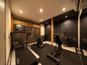 a room with a gym with a treadmill and a tv at Ryokan iriya in Tokyo