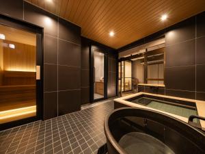 a bathroom with a tub in the middle of it at Ryokan iriya in Tokyo +49 photos