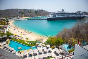 a cruise ship docked at a beach with a cruise ship at Casa Huatulco in Santa Cruz Huatulco