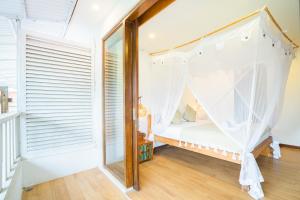 a bedroom with a bed with a mosquito net at Villas Shiva Complex in Uluwatu