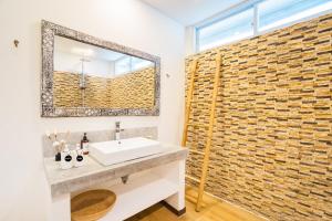 a bathroom with a sink and a mirror at Villas Shiva Complex in Uluwatu +59 photos