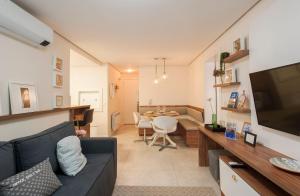 a living room with a couch and a dining room at Locar - in Canela Villaggio Caracol Novissimo in Canela