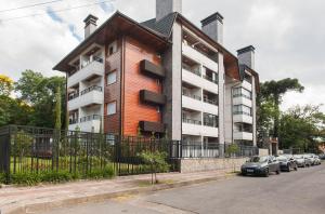 a large building with cars parked in front of it at Locar - in Canela Villaggio Caracol Novissimo in Canela