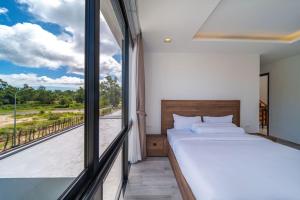 a bedroom with a bed and a large window at 5bdr pool villa in Laguna Park 2 in Phuket +64 photos