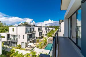 an apartment balcony with a view of a building at 5bdr pool villa in Laguna Park 2 in Phuket