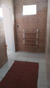 a room with a bench and a brick wall at Recanto verde pousada in Angra dos Reis