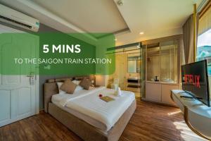 a bedroom with a large bed and a television at Cactusland Boutique Hotel in Ho Chi Minh City