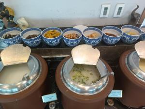 a display of different types of food in bowls at Novotel Atlantis Shanghai - Enjoy our great-valued breakfast in our rooftop revolving restaurant with a stunning river view & utilize our FREE self-serviced laundry in Shanghai