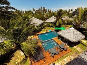 an aerial view of a resort with a swimming pool at Atins Charme Chalés in Atins