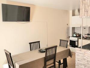 a dining room with a table and chairs and a refrigerator at Dptos en Consorcio Florentino in San Juan +27 photos