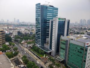 an aerial view of two tall buildings in a city at Minimalist and Comfy 1BR at The Boulevard Apartment By Travelio in Jakarta