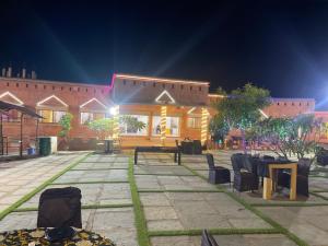 a building with a table and chairs in front of it at Royal villa resort in Amravati