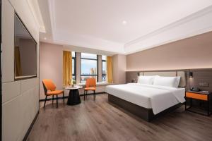 Una cama o camas en una habitación de 沃德酒店郑州大学高新校区店