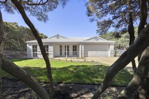 a white house with trees in front of it at Harlech House Rye in Rye