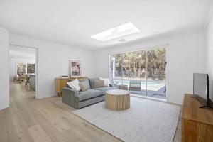 a living room with a couch and a table at Harlech House Rye in Rye