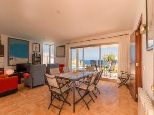 a dining room with a table and chairs and a living room at Cozy Vista Mar Azul in Cala Murada in Cala Murada