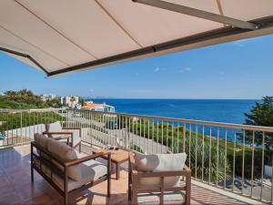 a balcony with chairs and a table and the ocean at Cozy Vista Mar Azul in Cala Murada in Cala Murada