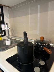 a pot and a knife on a stove in a kitchen at Mount Austin Lake View in Johor Bahru